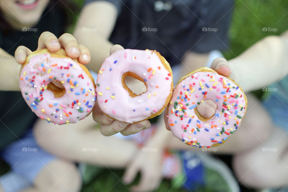 Children holding doughnuts in their hands
