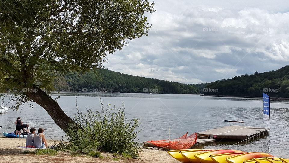 Lake beach in Brittany with kayaks