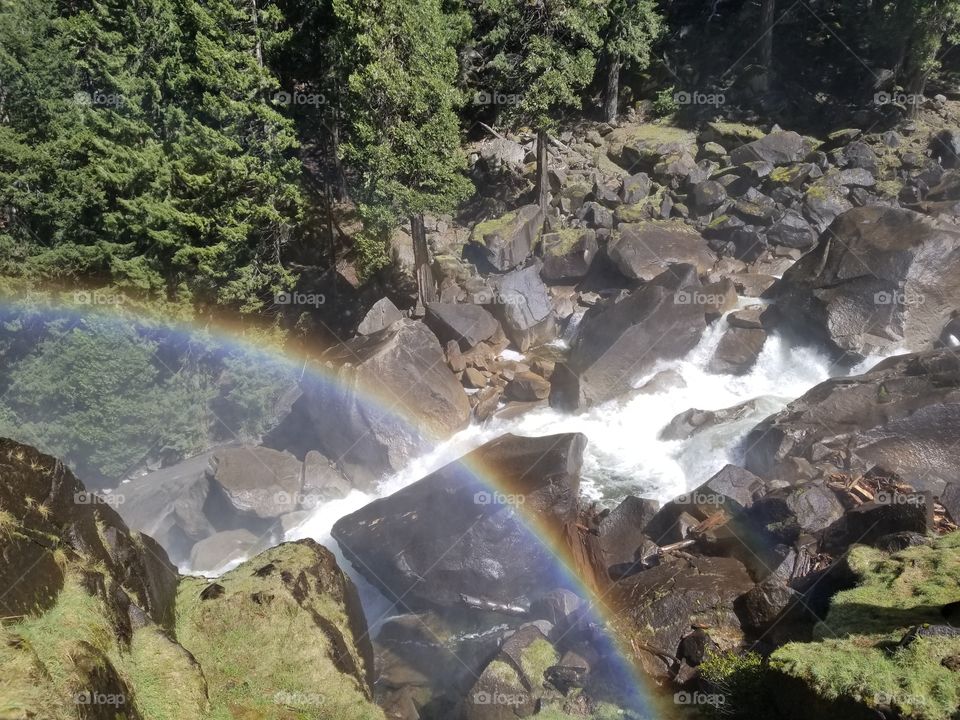 Yosemite waterfall with giant rainbow