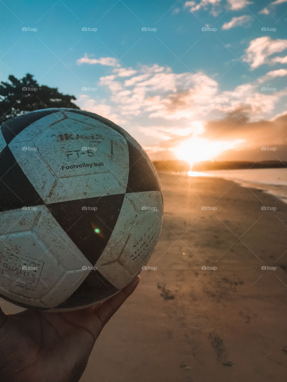 playing footvolley on the beach with a beautiful sunset