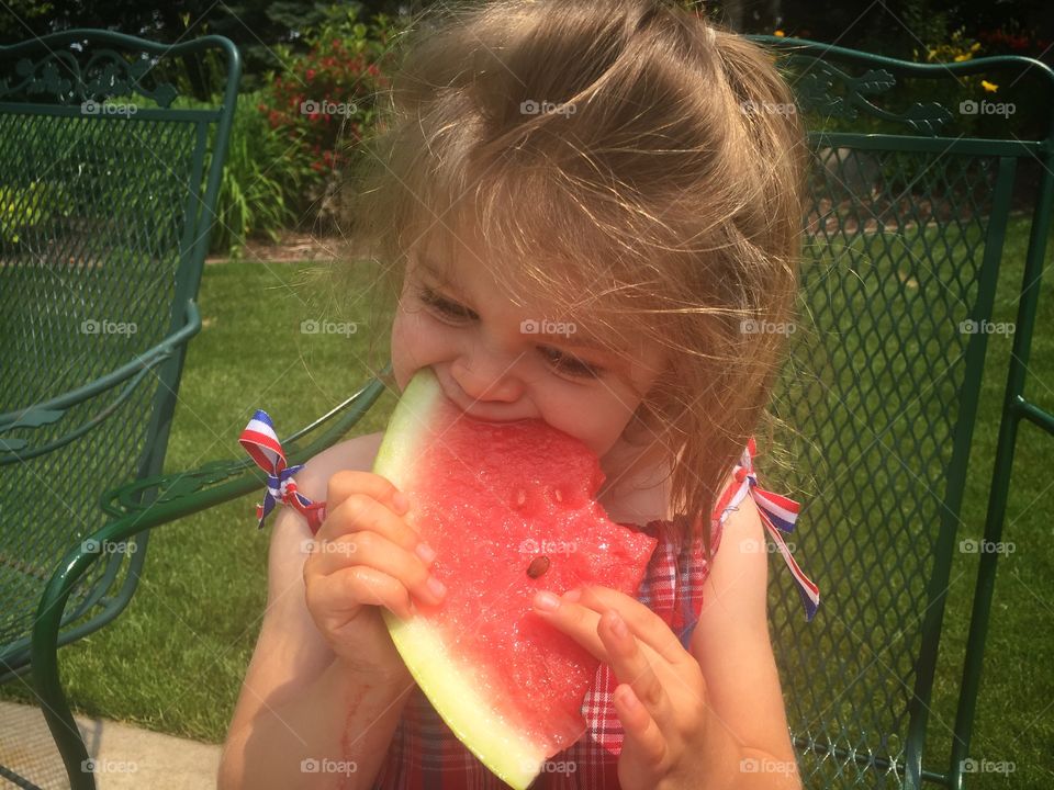 Cute girl eating watermelon