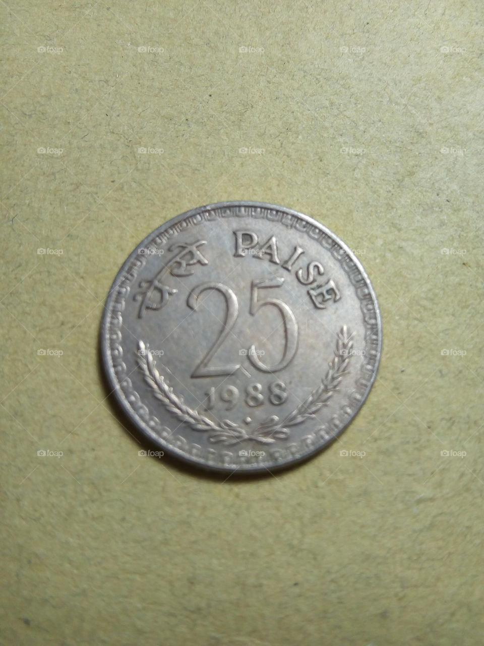 A coin of Twenty Five paise- 1/4 share of Indian Rupee issued by Government of India in 1988.