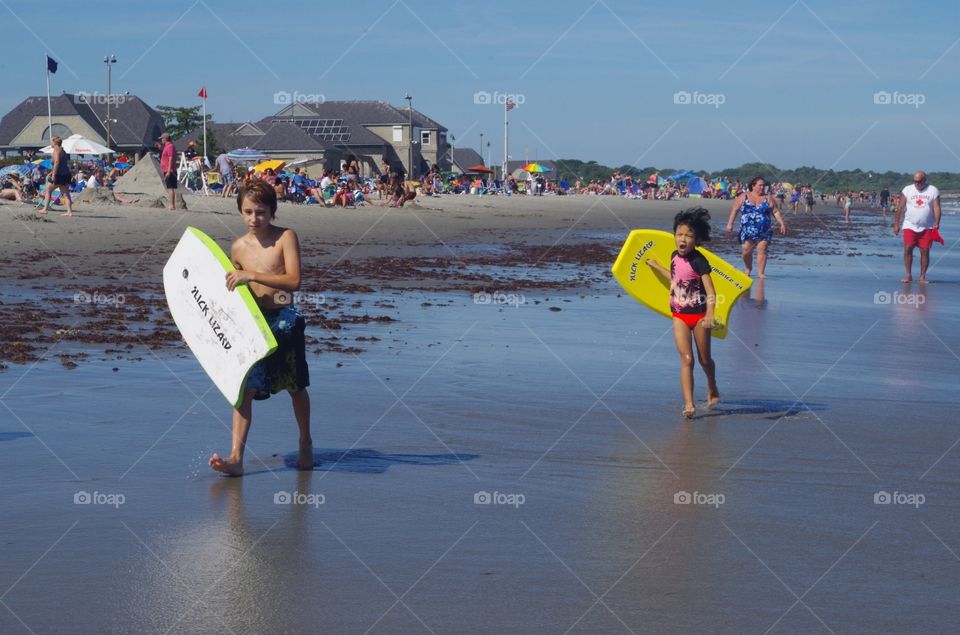 Wake boards and kids at beach