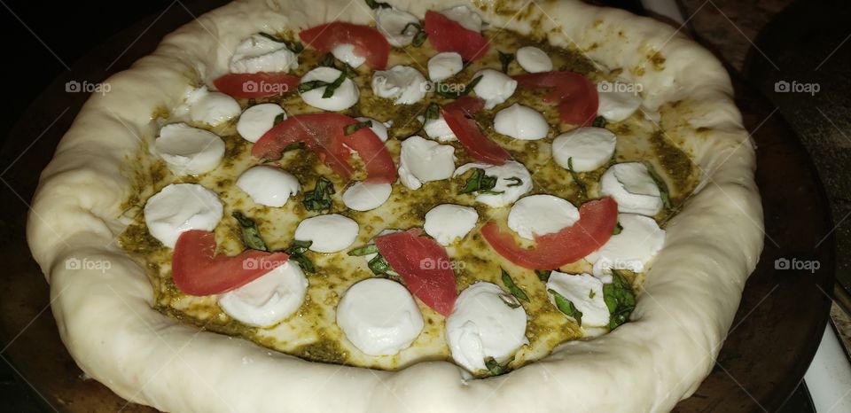 Unbaked pesto pizza