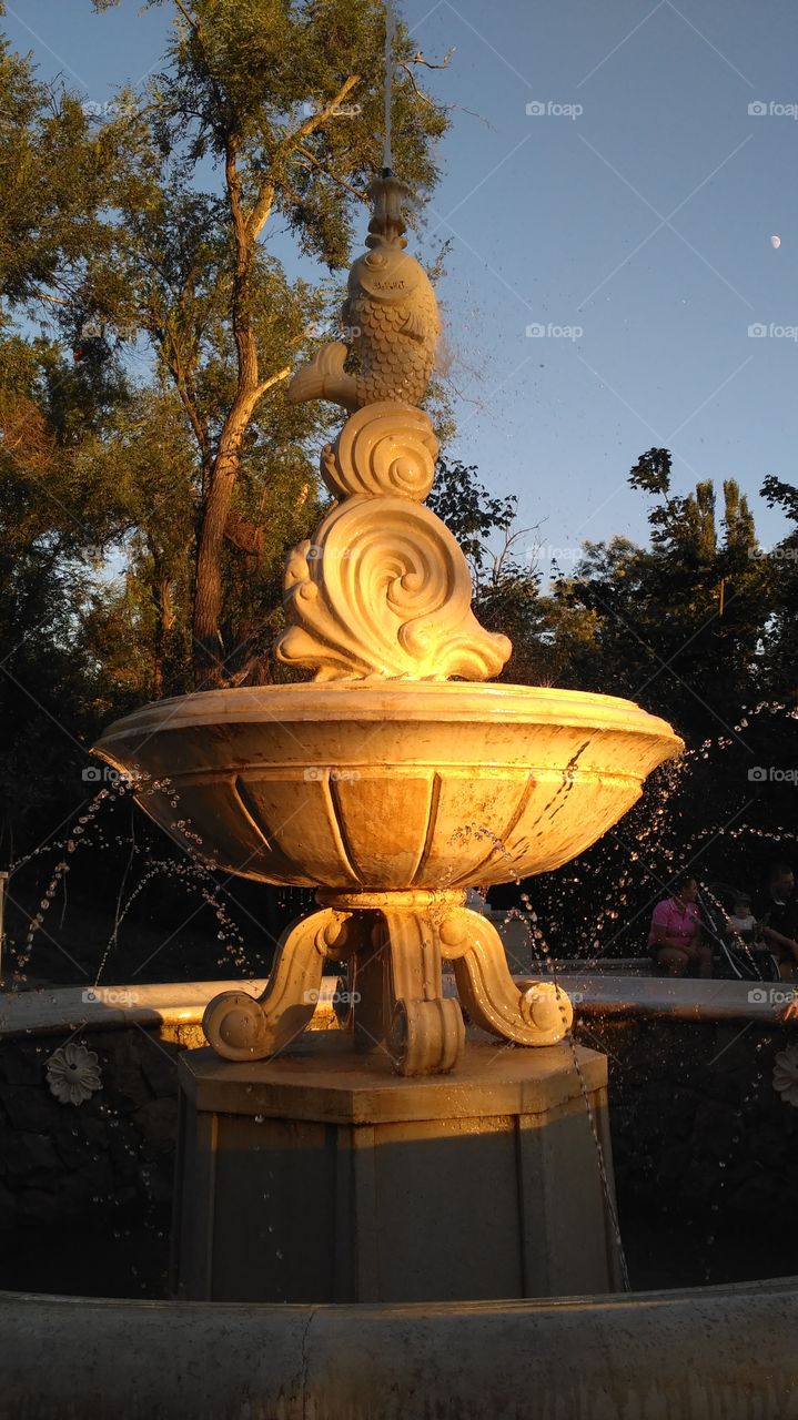 Old fountain lit by the setting sun
