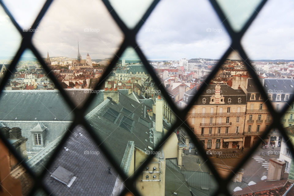 View of Dijon, France through stained colored glass.