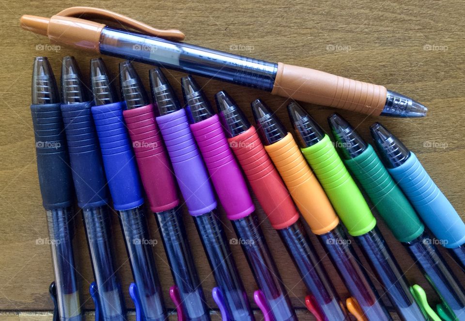 Colorful pens on drafting table 