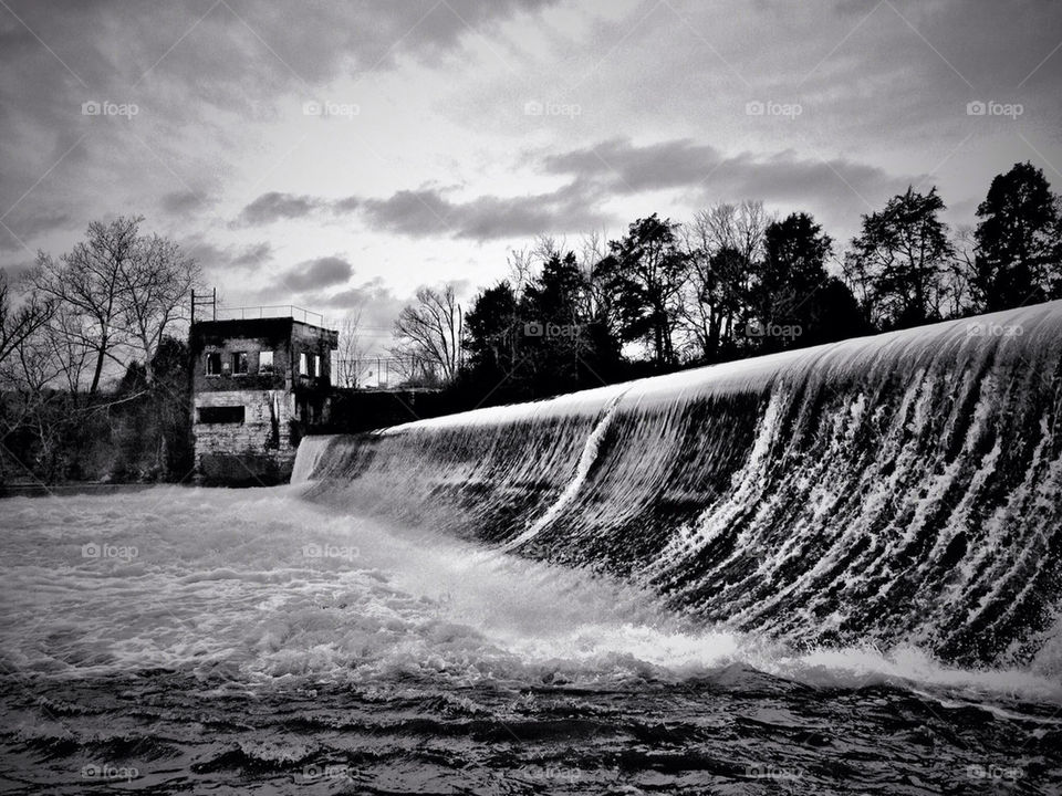 water black and white dam flowing by jasonoleham