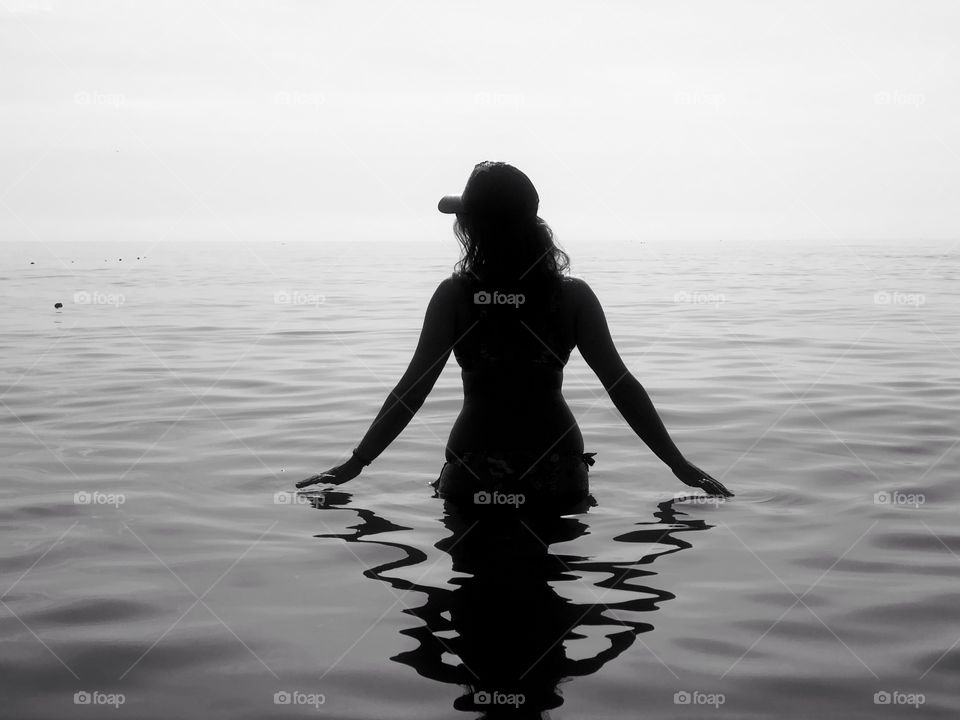 Silhouette of woman in water