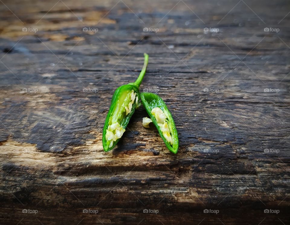 chilies that are split in half on the wood