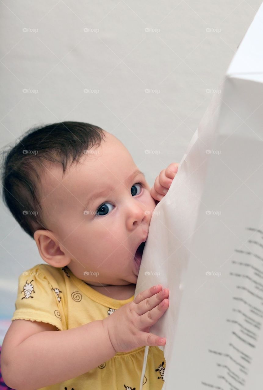 Baby eating a shopping bag