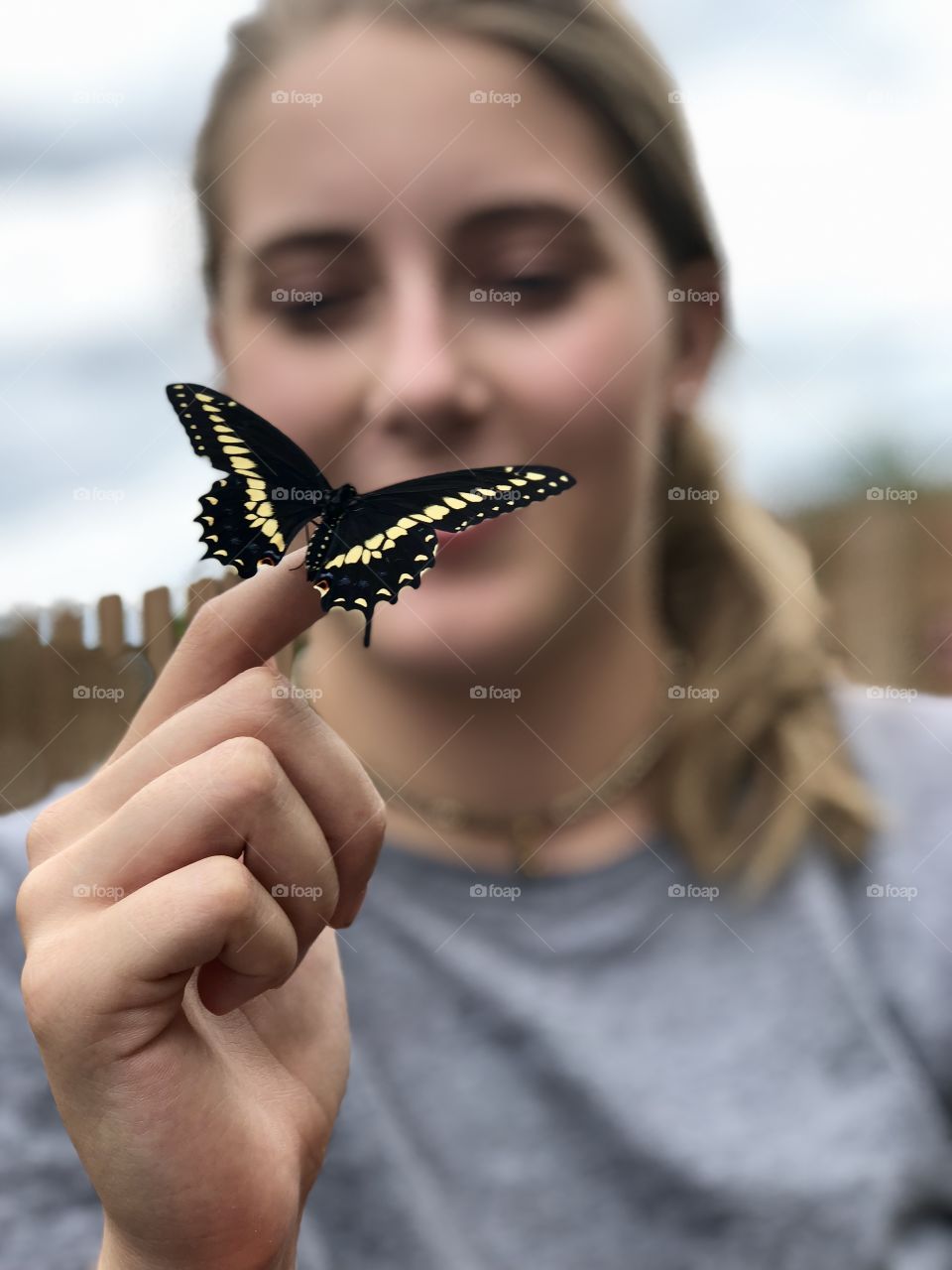 Girl holding a swallowtail butterfly