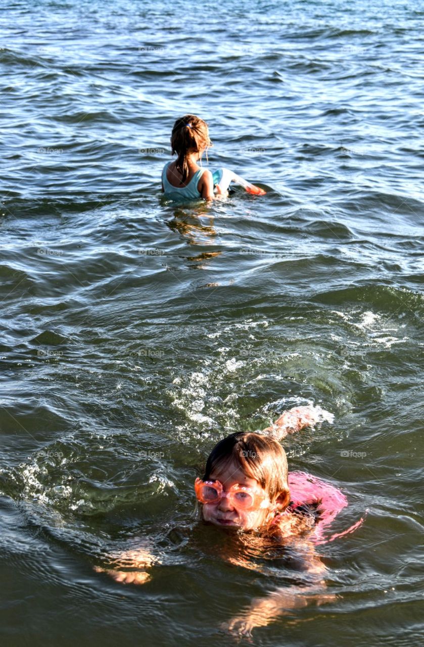 2 little girls enjoying the sea water