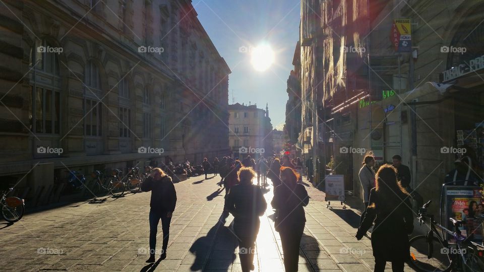 Walking towards the sun on a street in Montpellier, France