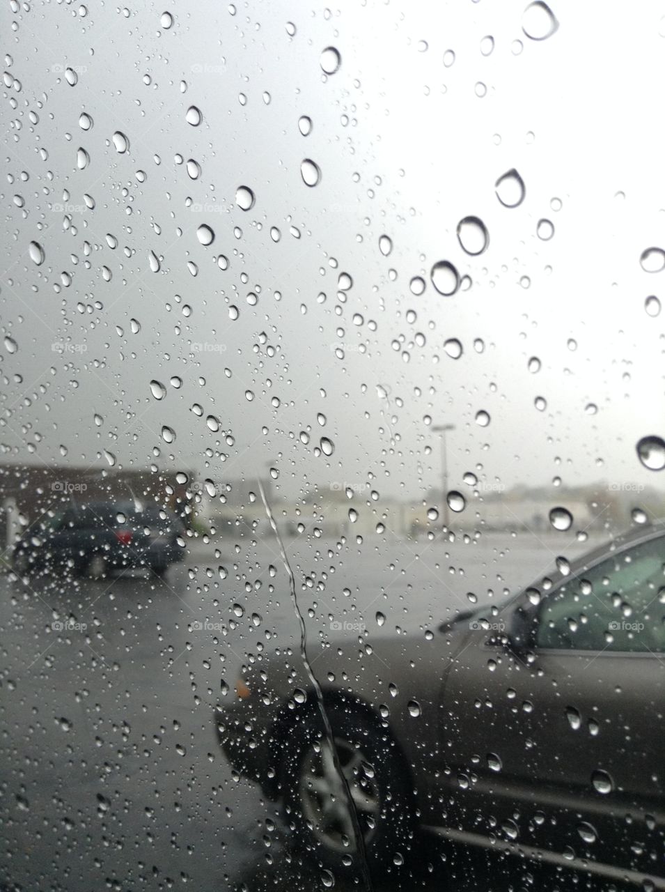 rain on a window taken in a parking lot