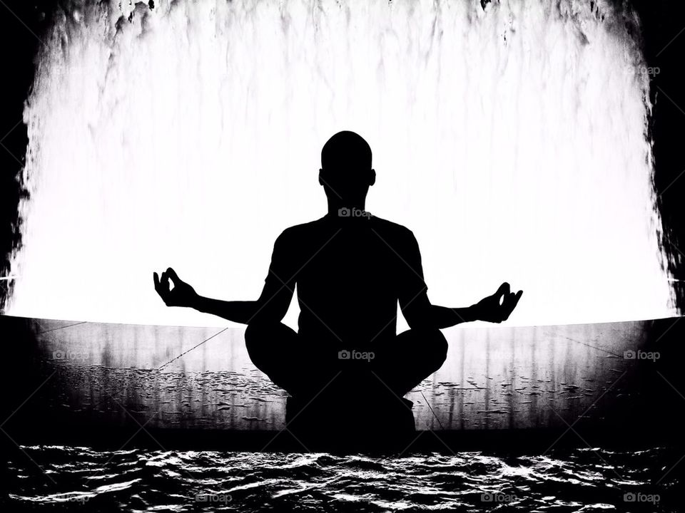 Silhouette of man in yoga pose