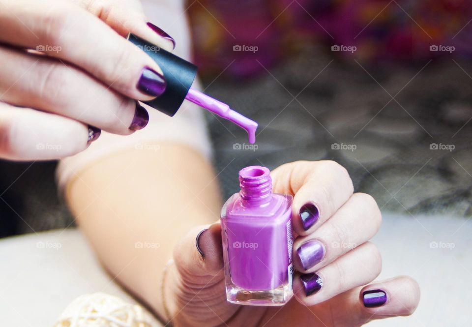 woman paints her nails with varnish