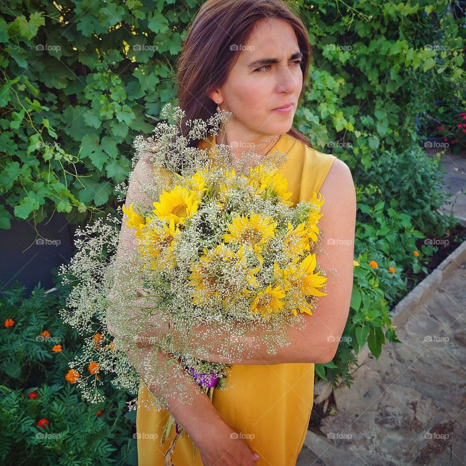 beautiful woman in a yellow dress. The most beautiful thing in our life is mom