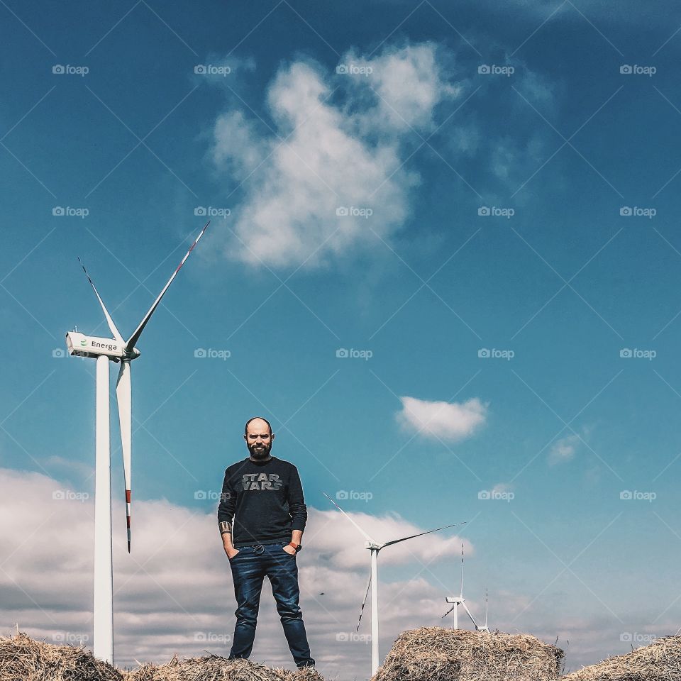Happy man standing near the windmill