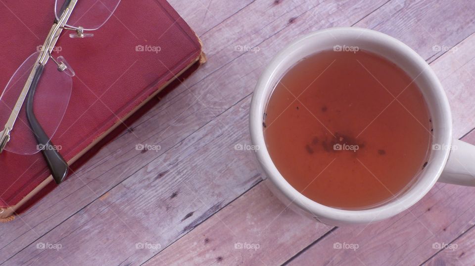 Tea with book and eyeglasses