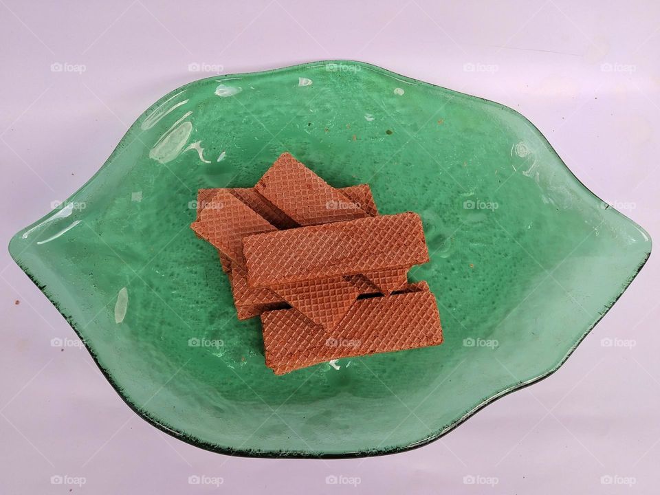 A pile of wafers on a green plate