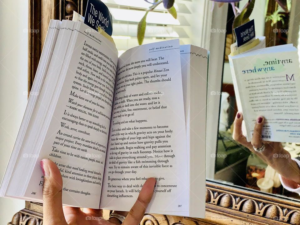 A person reading a meditation book