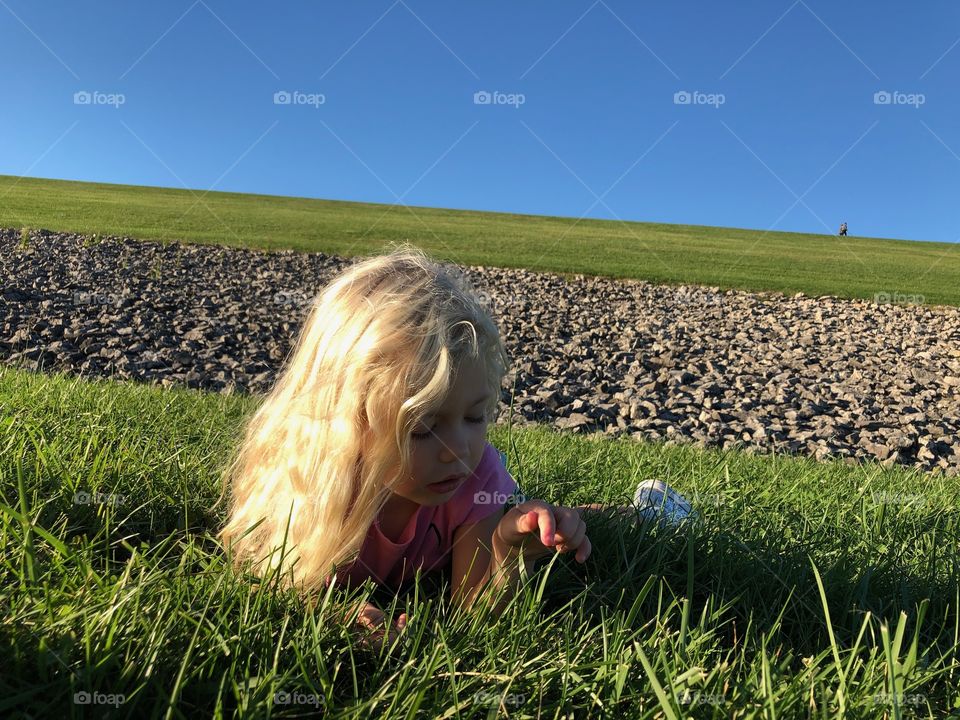 Beautiful girl daydreaming on a sunny summer day 