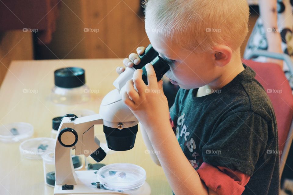 Boy looking in a microscope