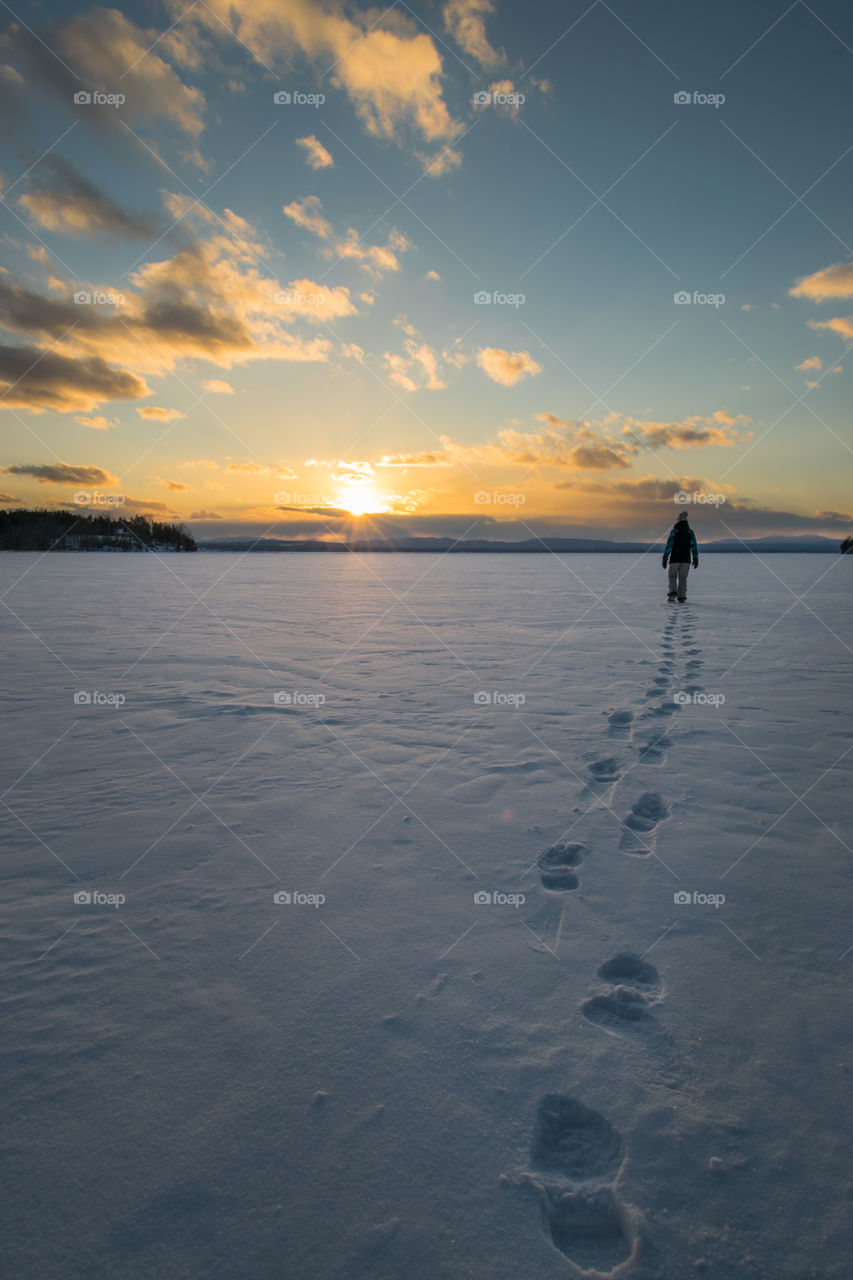 A walk across a lake made possible by freezing temperatures and sunset is the perfect time