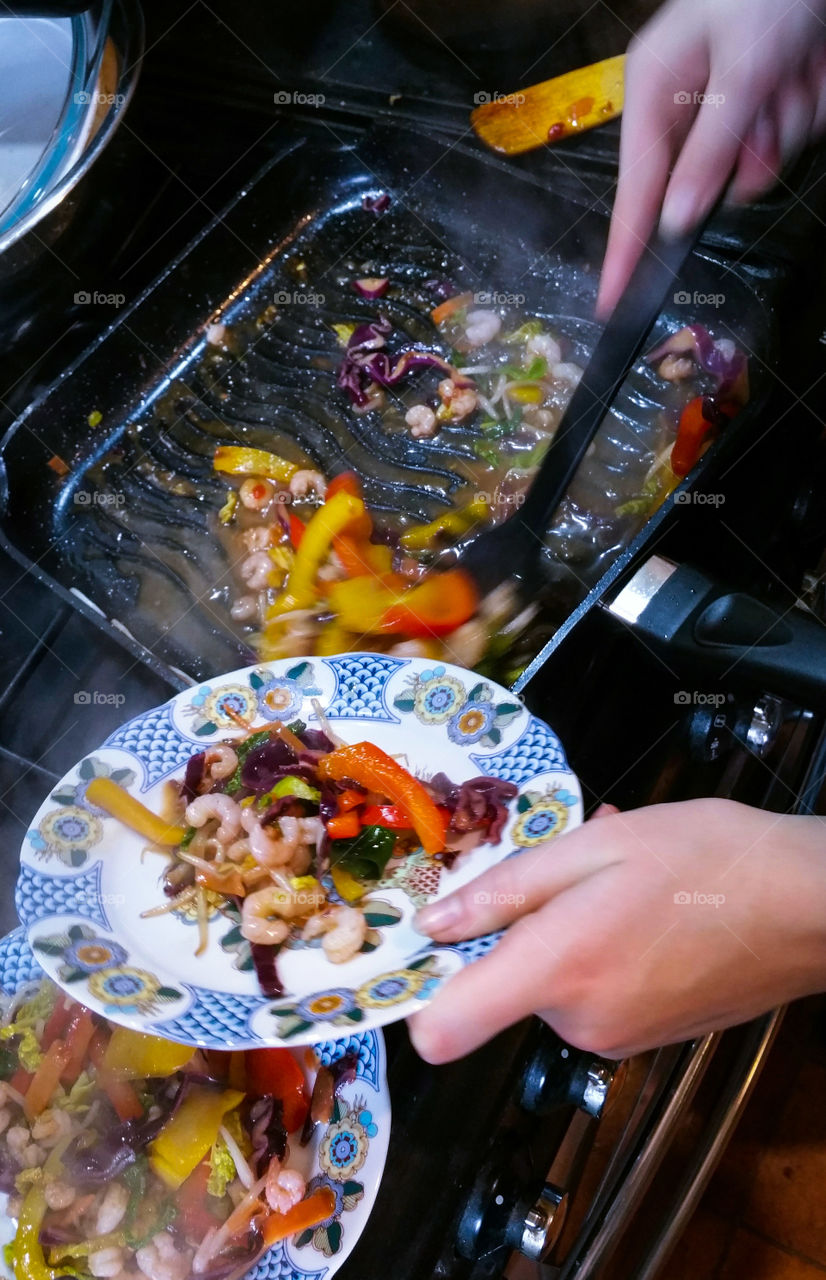 Dishing out the prawn and vegetable stir fry with sweet chilli sauce