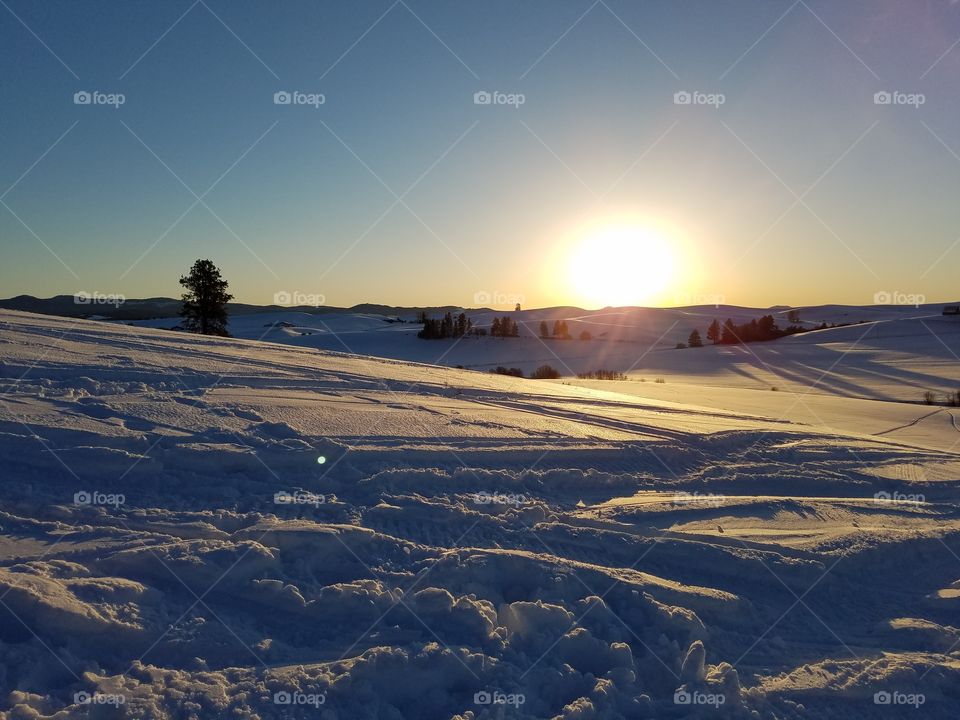 Scenic view of snowy landscape at sunset
