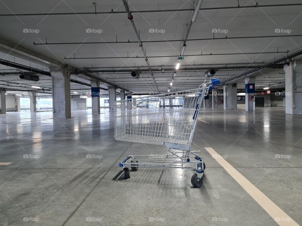 empty shopping cart in the middle of the underground parking