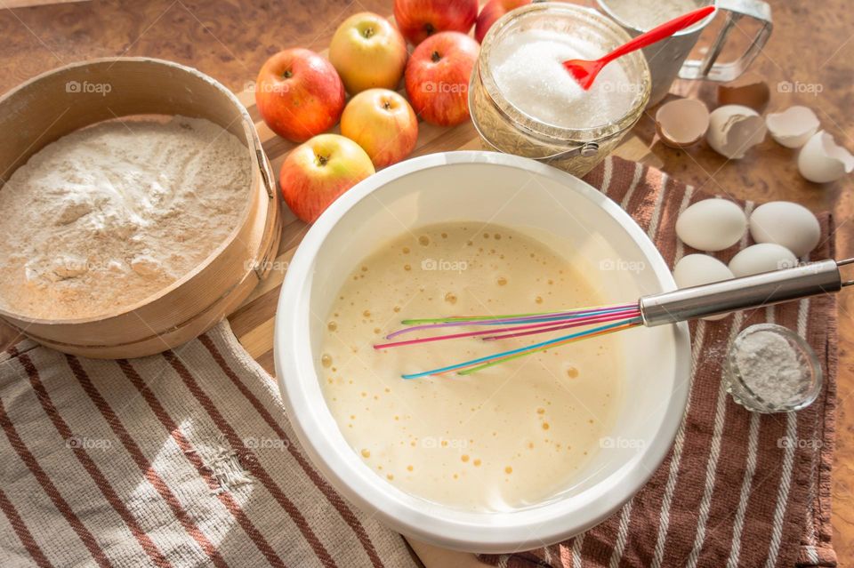 Making homemade puffed apple pie with eggs, sugar and flour.