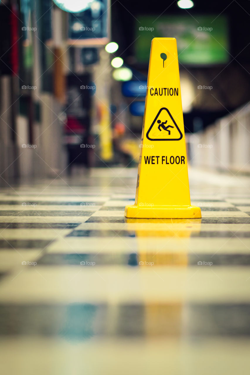 Yellow caution sign for wet floor