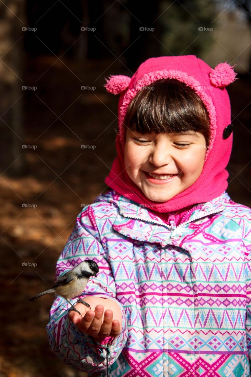 Happy girl with chickadee