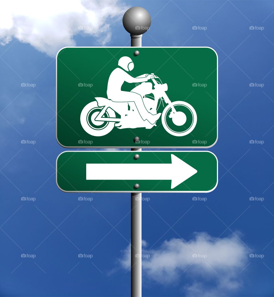 Green Road sign with motorcycle silhouette and arrow pointing Direction against Blue Sky with clouds