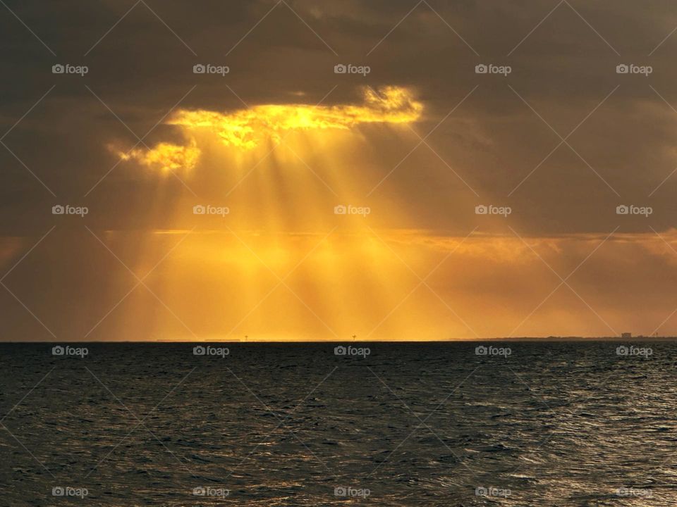 Spectacular Yellow sun rays - Crepuscular rays (also called sun rays and sunbeam) are created when sunlight shines through gaps in clouds  and continues through an atmosphere that contains dust or haze