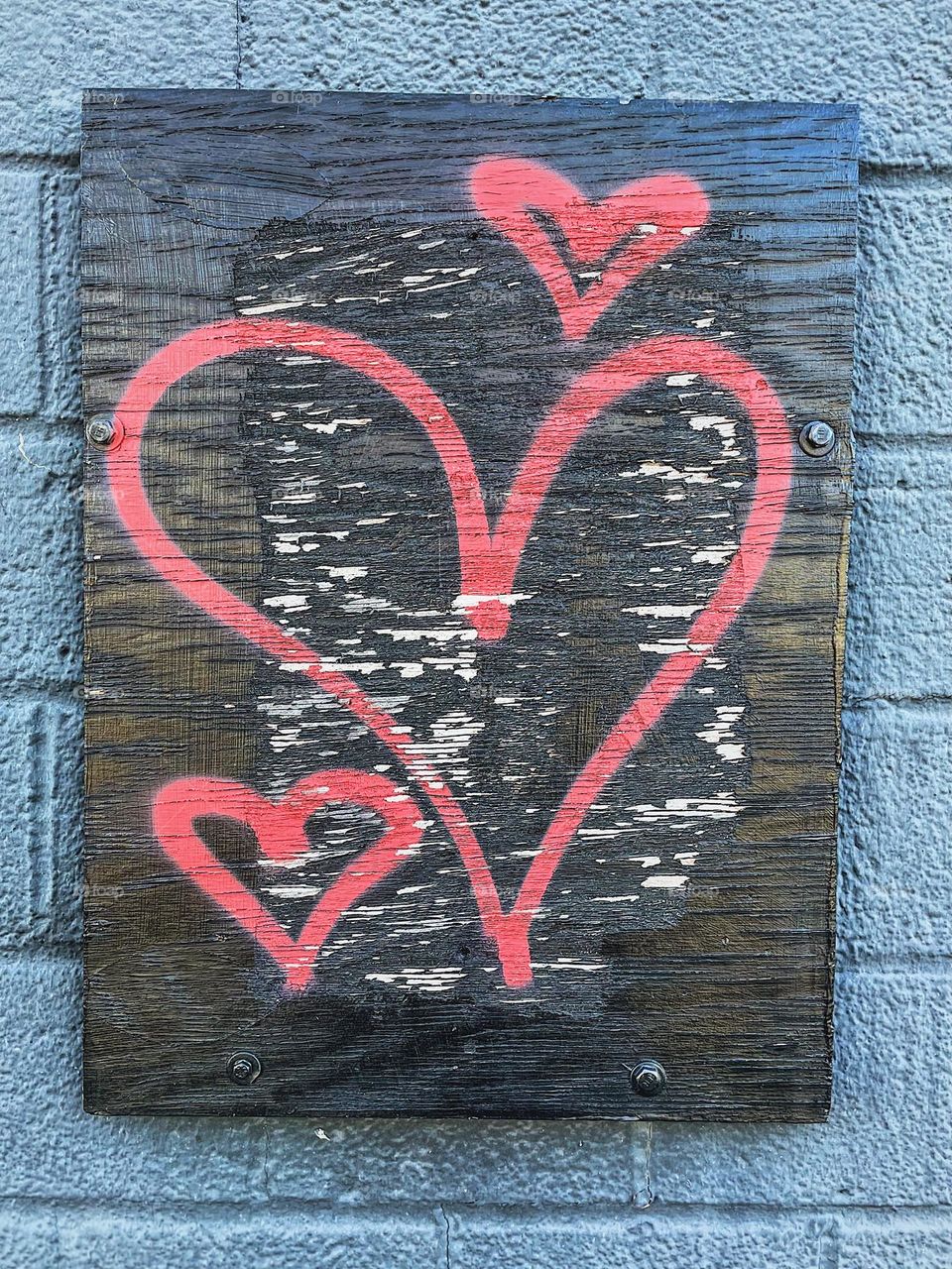 Heart graffiti outside of a record shop in Ohio, Midwest love and graffiti, music and love, hearts spray painted onto a building, heart graffiti on a building, cool hearts spray painted in red, fun graffiti