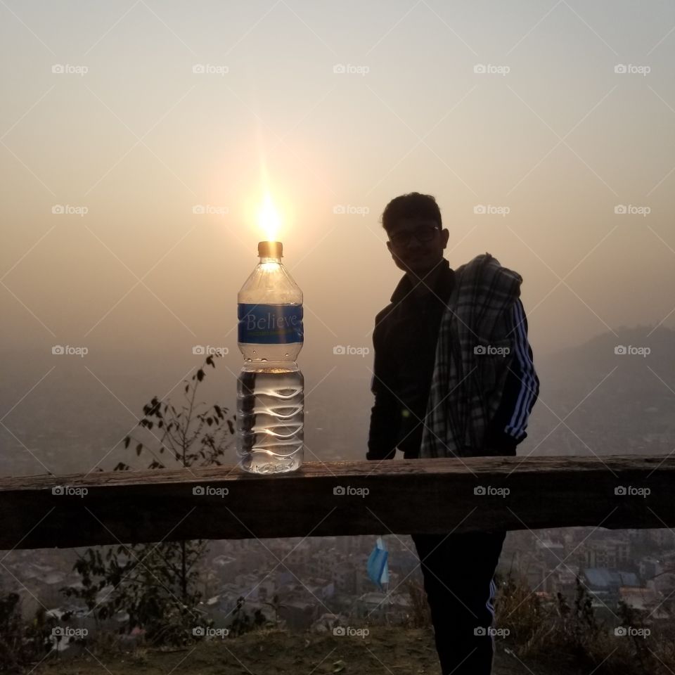 hiking with water bottle in beautiful sunrise