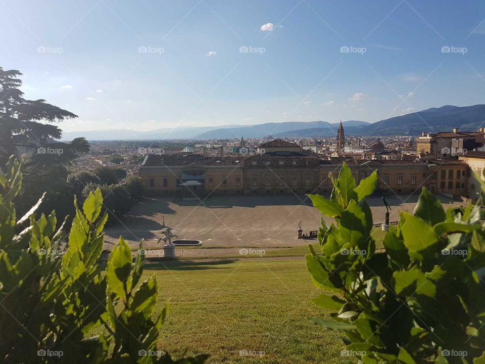 View of Palazzo Pitti in Florence from the Boboli Garden in a clear blue sky.