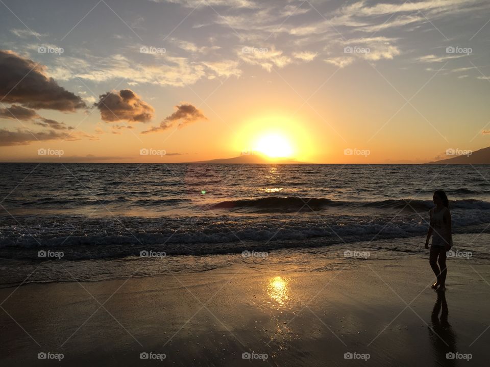 A person standing near sea