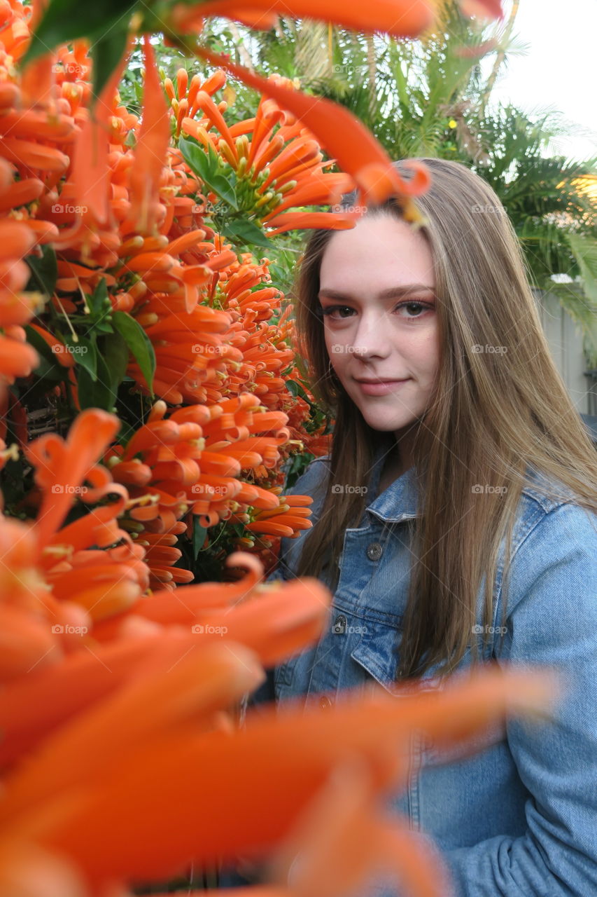 A fairy in the garden, pops of orange, blossoming beauty.