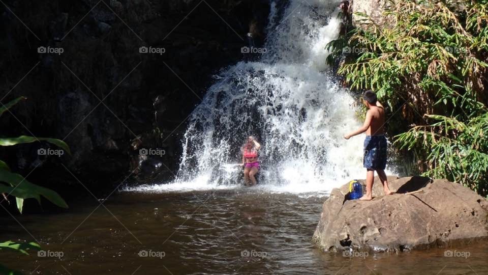 While hiking in Kauai we found a waterfall and a native dared me to go under it. It was freezing and extremely forceful! 