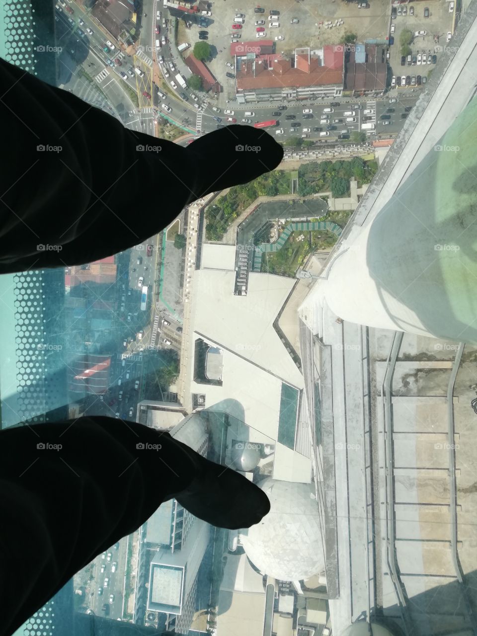 Perspective of the city of Penang photographed from a tower, on a glass platform