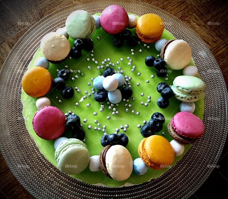 Lime cheesecake with blueberries, candies and macarones