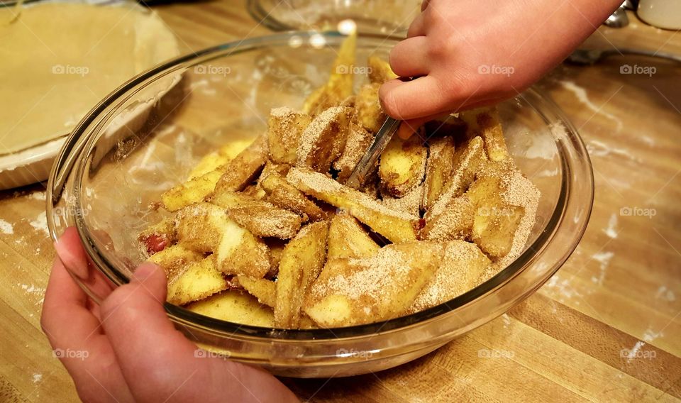 Person preparing apple pie