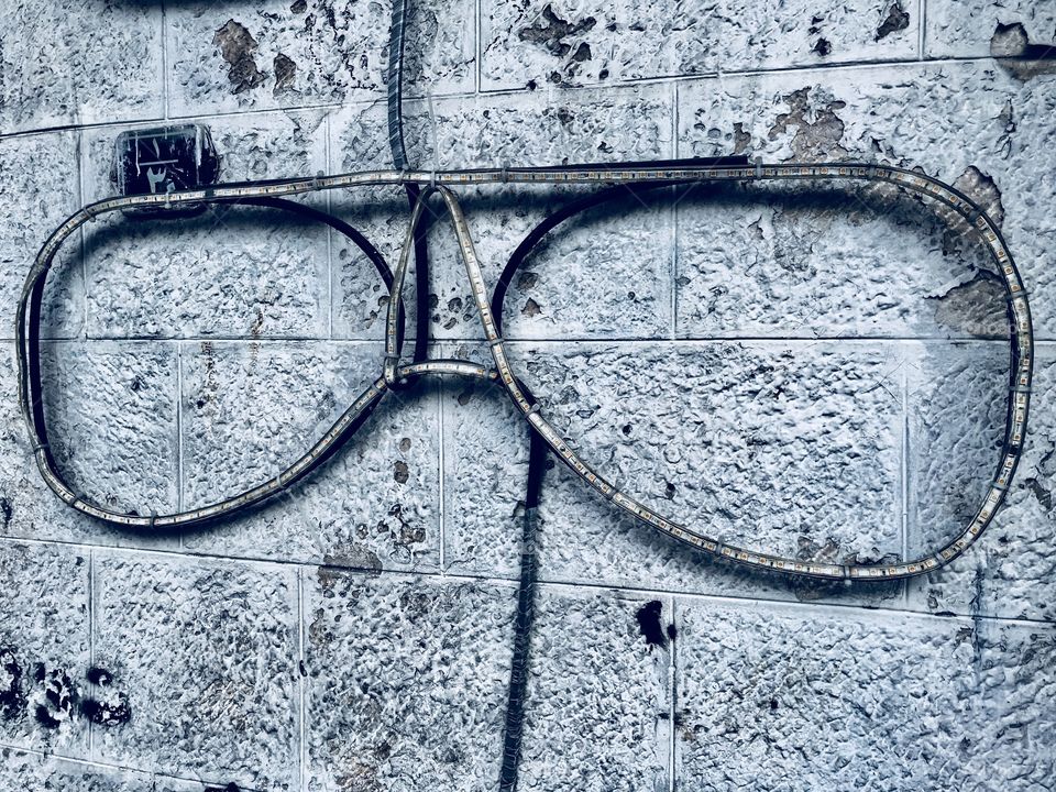 Big eye glasses on a stony wall