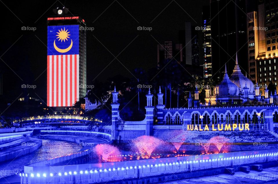 Night scenery of Masjid Jamek, Kuala Lumpur Malaysia,with neon lights and fog  along the River of Life.