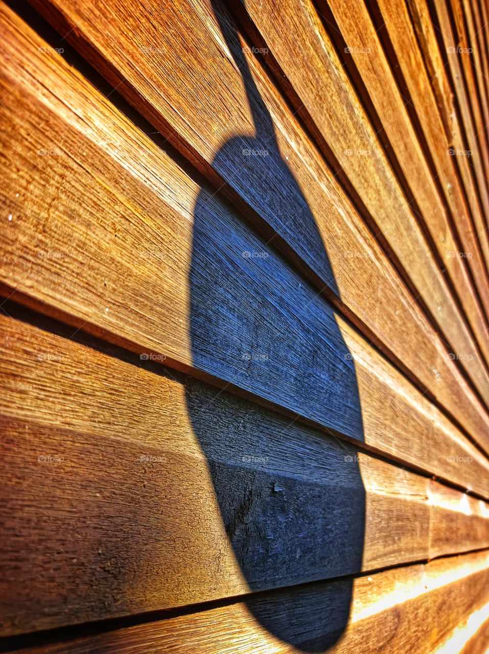 Circle shadow on wooden wall