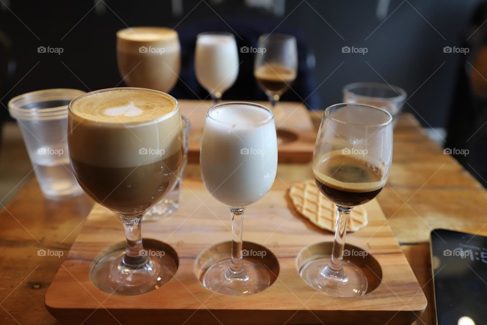 Coffee in a glass on a wooden tray